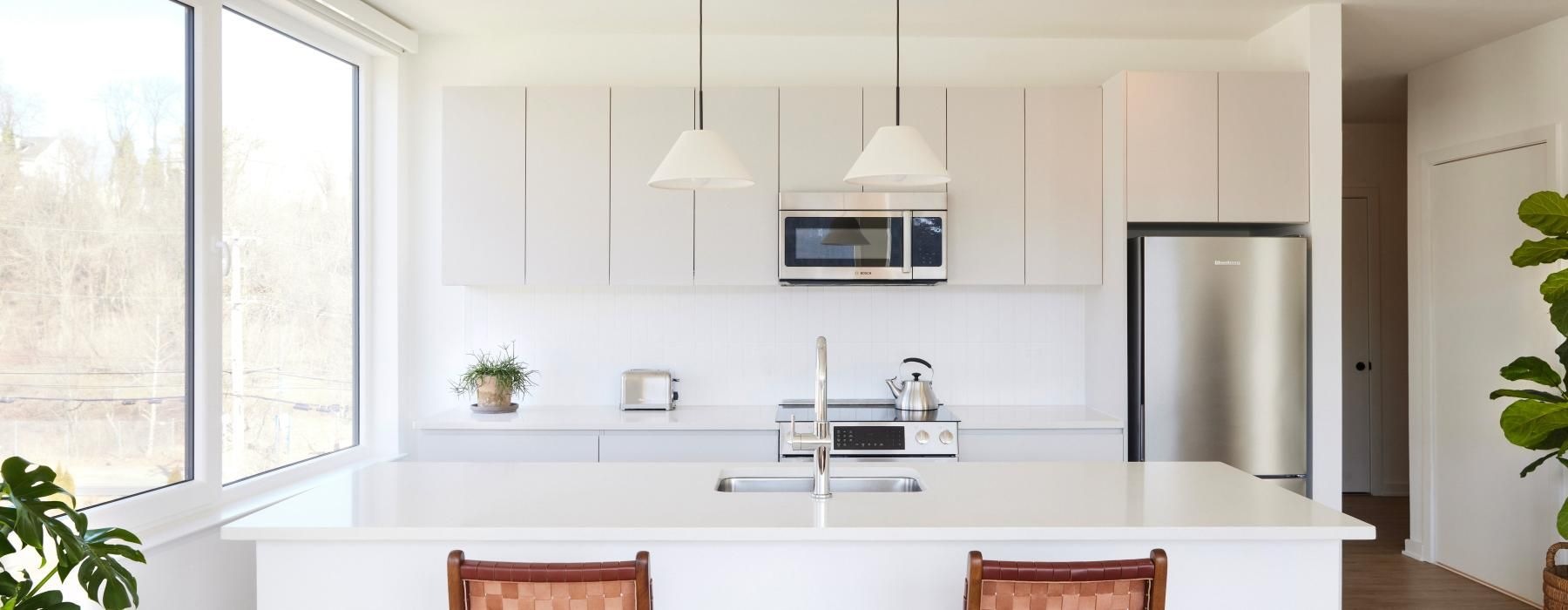 a kitchen with white cabinets