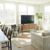 A living room with a large window and couch at The Driftway luxury apartments in Philadelphia