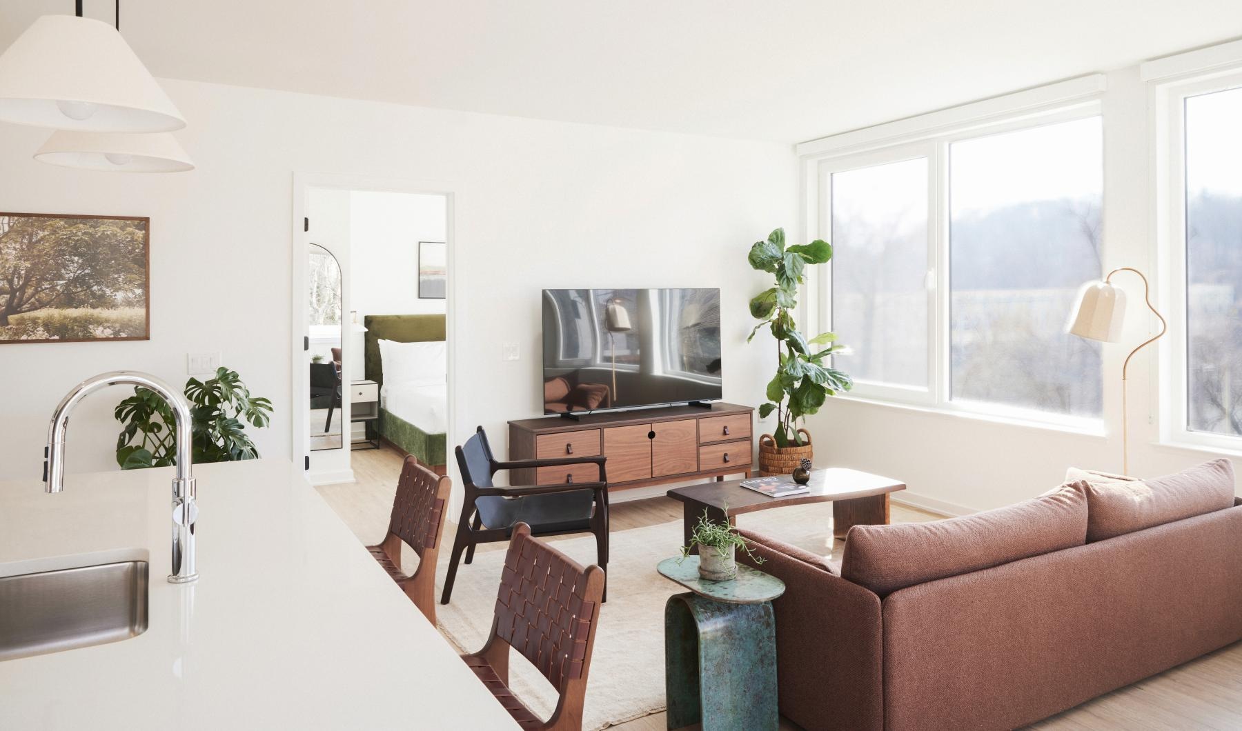 a living room with large window and a couch